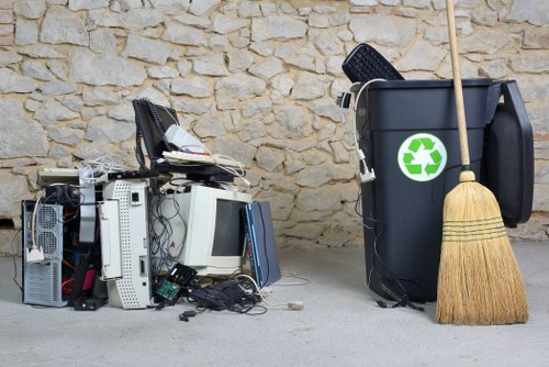 Assorted office furniture and electronics being cleared